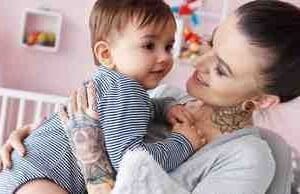 A woman holding a baby in her arms.