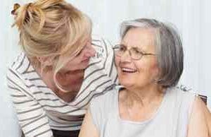 A woman and an older person smiling for the camera.