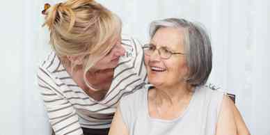 A woman and an older person smiling for the camera.