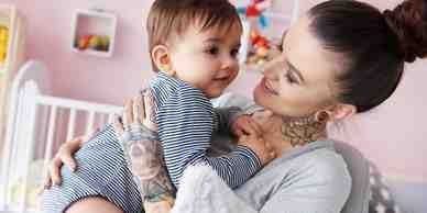 A woman holding a baby in her arms.